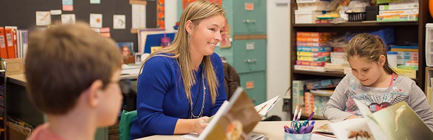 Teacher working with children