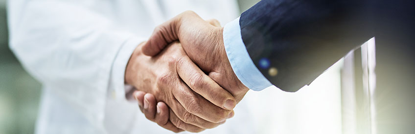 Business person shaking Doctor's hand