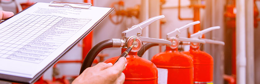 Person inspecting fire extinguishers