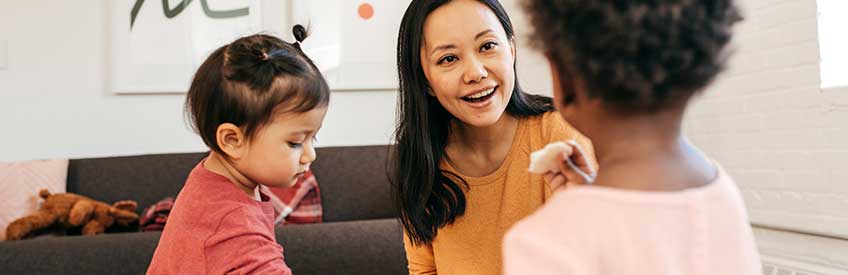 Home child care worker working with 2 kids