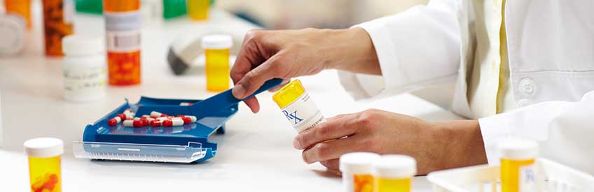 Pharmacy technician counting capsules