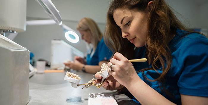 Dental Assistant working on dentures