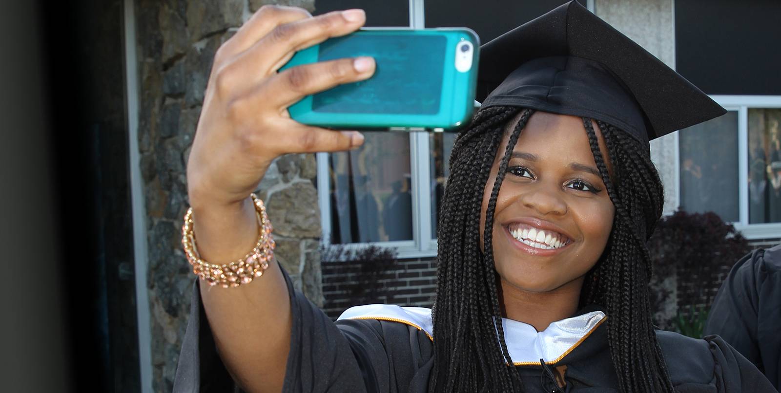 Student in Grad cap smiling